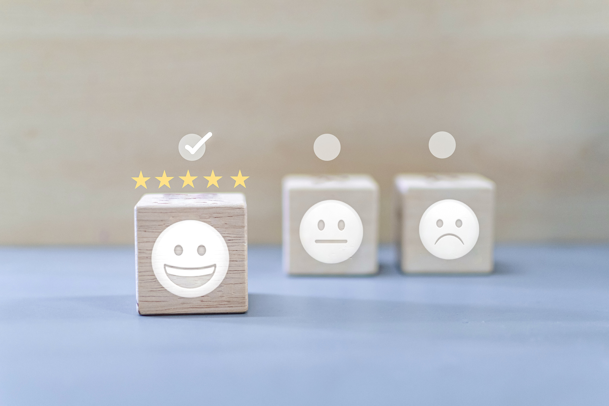 Emojis on wood blocks with stars for ratings above them