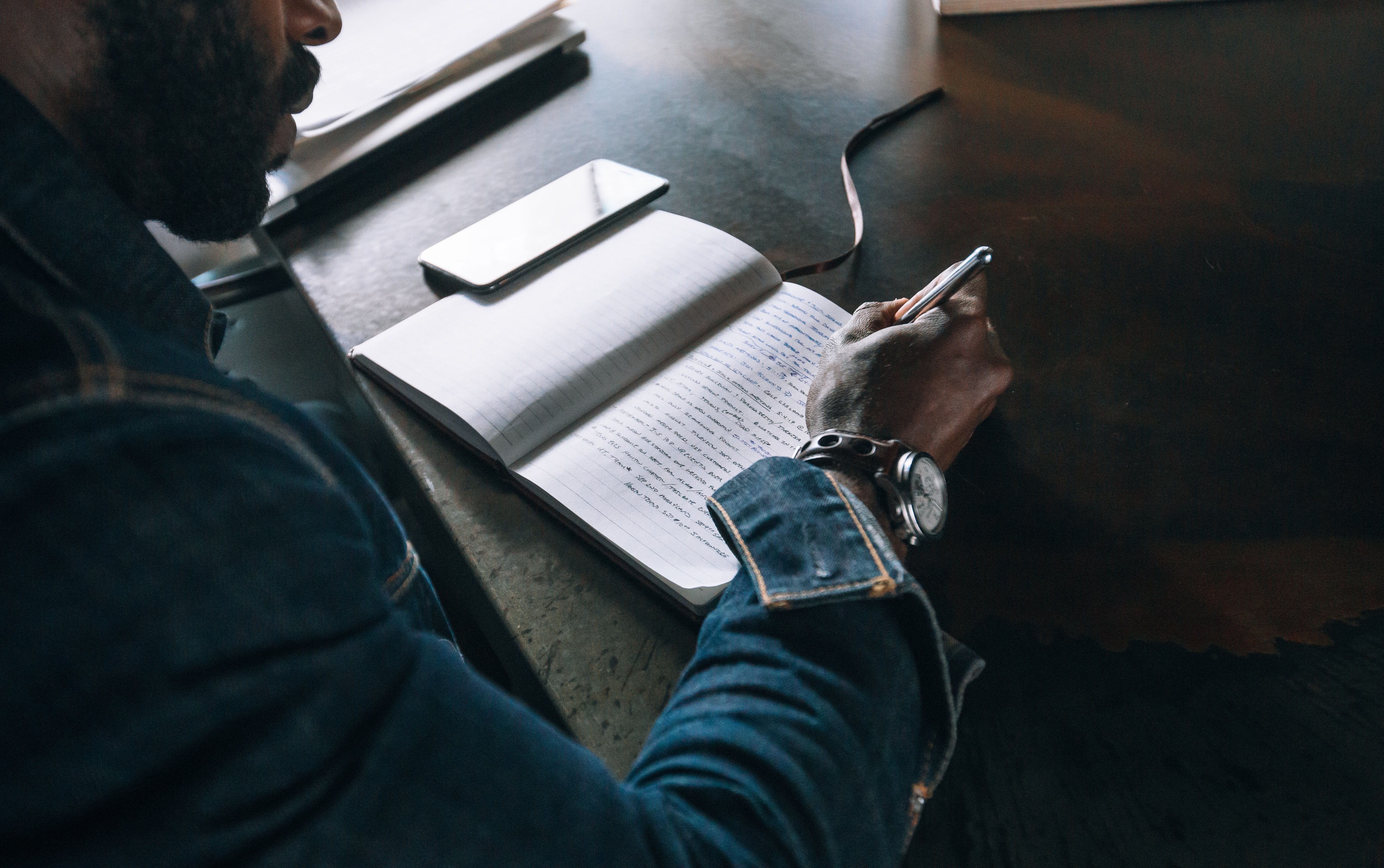 Man Writing in Journal